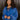 Front view of model wearing the Long Live Sweatshirt, which features washed blue fabric, a 3/4 snap-up neckline with a small collar, raglan balloon sleeves with ribbed cuffs, and a ribbed hemline