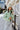 Front view of model wearing the Aspen Puffer Jacket in Green, that has diamond stitching. a high neckline, a monochromatic front zipper, two front pockets, a cropped waist, and long sleeves. Worn unzipper over olive top.