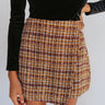 Close-up front view of model wearing the See You There Tweed Skort, which features a multi-colored tweed fabric, a shorts back, and a front skirt overlay. Worn with black bodysuit