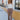 Full body front view of model wearing the Don't Wait Up Pants, that have brown woven fabric with front pleating, a front zipper and hook closure, side pockets, and faux back pockets