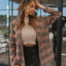 Front view of model wearing the Double Take Houndstooth Blazer, that has a black and mocha houndstooth pattern, tortoise buttons on each, front slit pockets, and long sleeves.