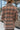 Back view of model wearing the Double Take Houndstooth Blazer, that has a black and mocha houndstooth pattern, tortoise buttons on each, front slit pockets, and long sleeves.