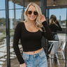 front view of model wearing the On Repeat Top, which features soft knit fabric, a scoop neckline, long sleeves, and a slim fit features soft double-layer knit fabric, a scoop neckline, long sleeves, and a slim fit. 