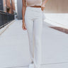 Front view of model wearing the At Your Leisure Pants, which feature ribbed knit beige fabric and an elastic waist.