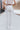 Back view of model wearing the At Your Leisure Pants, which feature ribbed knit beige fabric and an elastic waist.