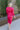 Back view of model wearing the New Look Midi Dress, that has pink satin fabric with a ruched midi-length skirt, a v-neckline, 3/4 length sleeves with ruching at the wrist, a back zipper and hook closure with a keyhole cutout