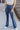 Front view of model wearing the Walk The Line Velvet Pants, which feature blue velvet with vertical and diagonal ribbed panels, flared legs, and a high-rise elastic waist.