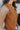Close-up side view of model wearing the Make It Count Tank Top, which features pleated fabric, a cropped waist, a sleeveless body, and a high neckline. 