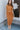 Full body front view of model wearing the Make It Count Skirt, which features pleated fabric, an elastic waist, and a midi-length. Worn with matching top.