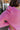 Close-up back shoulder view of model wearing the Lucky Me Sweater in Pink.