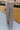 Front view of model wearing the New In Town Tweed Pants, which feature brown and black tweed fabric, a paperbag waist, a matching belt with a gold buckle, and wide legs.