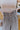 Close-up upper front view of model wearing the New In Town Tweed Pants, which feature brown and black tweed fabric, a paperbag waist, a matching belt with a gold buckle, and wide legs.