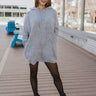 Front view of The Lift Me Up Sweater Dress features heather grey knit fabric, side pockets, hoodie attached with thick drawstrings and long sleeves.