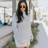 Front view of The Heathered Haze Sweater features heather grey cable knit fabric, monochromatic checkered pattern, slouch turtle neck, cable knit hem and long sleeves with cable knit wrists.