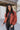 Front view of The Madison Jacket features rust lightweight fabric, cropped waist, grey front zip up, two pockets with zipper closures, high neckline and long balloon sleeves with elastic wrists.