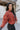 Side view of The Madison Jacket features rust lightweight fabric, cropped waist, grey front zip up, two pockets with zipper closures, high neckline and long balloon sleeves with elastic wrists.
