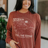 Front view of Feel The Sunset Top featuring rust two-tone color fabric, desert graphic, "DESERT" and "FEEL THE SUNSET" displayed, and long sleeves with cuffs