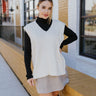 Front view of the In Session Sweater that features cream knit fabric, cable knit and checkered pattern, v neckline, ribbed knit fabric details on the hem, and sleeveless.