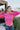 Front view of model wearing the Center Of Attention Sweater that has hot pink knit fabric, thick ribbed details, a round neckline, a front triangle hem, a straight hem in the back, and long sleeves