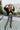 Front view of the Where You've Been Sweater in Black that features black small cable knit fabric, v neckline with cable knit lining, slits on each side of the hem, dropped shoulders and long sleeves with cable knit wrists.
