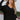 Front view of the Where You've Been Sweater in Black that features black small cable knit fabric, v neckline with cable knit lining, slits on each side of the hem, dropped shoulders and long sleeves with cable knit wrists.