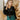 Front view of model wearing the The Late Nights Velvet Top that has  black velvet fabric, a cropped waist, ruched front detailing, a  v neckline, and long sleeves with elastic wrists.

