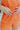 The Something Orange Ring Set is a set of three rings; a gold band with pink and orange hearts, a gold band with pink flowers, and a thick gold band with one large orange flower.