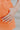 The Something Orange Ring Set is a set of three rings; a gold band with pink and orange hearts, a gold band with pink flowers, and a thick gold band with one large orange flower.