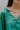 Frontal view of the In Charge Top that features a green colored material, a round neck with an adjustable tie closure, a notched neckline, a long sleeve, and a flowy fit.