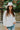 Frontal view of the In Charge Top In Ivory that features an ivory colored material, a round neck with an adjustable tie closure, a notched neckline, a long sleeve, and a flowy fit.