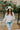 Frontal view of the In Charge Top In Ivory that features an ivory colored material, a round neck with an adjustable tie closure, a notched neckline, a long sleeve, and a flowy fit.