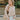 Frontal view of the To The Moon and Back Top that features a brown knit material, a quilted design, a V neckline, long sleeves, side slits, and a flowy fit.