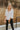 Frontal view of the Don't Forget Me Top that features an ivory satin material, a V neckline, a cutout at the bust, a ruched design at the bust, a long sleeve, an open back with tie detailing, and a flowy fit.
