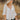 Frontal view of the Don't Forget Me Top that features an ivory satin material, a V neckline, a cutout at the bust, a ruched design at the bust, a long sleeve, an open back with tie detailing, and a flowy fit.