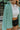 Frontal view of the Sloane Corduroy Shacket that features a jade green corduroy material, a collar neckline, a button-up front, a front pocket, and long cuffed sleeves.