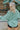 Back view of the Sloane Corduroy Shacket that features a jade green corduroy material, a collar neckline, a button-up front, a front pocket, and long cuffed sleeves.