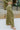 Side view of the All Your Life Pants that features a green satin material, a high-rise fit, a thick elastic waist band with an adjustable tie, and a wide leg fit.