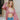 Frontal view of the Say No More Top that features a pink satin material, a monochromatic polka dot print, a collar neckline, a button-up front, a long cuffed sleeve with buttons on the wrists, and a rounded hem with side slits.