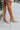 The Sutton Mule is a lug sole, mule style, featuring a nude leather upper, a slip-on entry, and a lug sole.