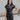 Frontal view of the Can't Live Without Mini Dress that features a black faux-leather material, a collar neck, a short cuffed sleeve, a button-up front, two front pockets at the chest, two front pockets at the bottom, and a mini length.