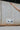 The Clear To Me Purse is a clear purse that can be worn as a crossbody or shoulder purse, featuring a quilted white stitching design, a gold chain with a white leather shoulder strap, and a clasp closure.