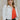 Frontal view of the Don't Get It Twisted Jacket that features a white faux leather material, a collar neck, a button-up front, a monochromatic white checkered print, front fringe detailing, and a cropped fit.