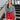 Frontal view of the Take It Back Top that features a washed black denim material, a V neckline, 3/4 sleeves, a ruched front, a keyhole buttoned back, and an elastic bottom hem at the back.
