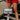 The Clear To Me Purse is a clear purse that can be worn as a crossbody or shoulder purse, featuring a quilted black stitching design, a gold chain with a black leather shoulder strap, and a clasp closure.