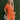 Frontal view of the Spur The Moment Denim Romper that features an orange denim material, a surplice neckline that snaps with a collar, half-length sleeves, a front zipper, pockets, pleating on the legs, and a 3" inseam.