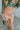 Frontal view of the You're Blushing Mini Skirt that features a pink colored tulle material, a draped design, a rose colored satin skirt lining, a back zipper closure, and a mini length.