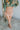 Frontal view of the You're Blushing Mini Skirt that features a pink colored tulle material, a draped design, a rose colored satin skirt lining, a back zipper closure, and a mini length.