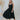 Frontal view of the Stealing Hearts Midi Dress that features a black colored silk material, a surplice neckline, a sleeveless design with thin adjustable straps, a pleated skirt, an open back with crossover straps and adjustable ties, and a midi length