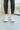 The Got To Go Sneaker features an ivory corduroy upper with grey colored suede paneling, a grey colored suede heel, a camel colored heel tab, two camel colored side stripes, and a lace-up closure.