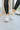 The Got To Go Sneaker features an ivory corduroy upper with grey colored suede paneling, a grey colored suede heel, a camel colored heel tab, two camel colored side stripes, and a lace-up closure.